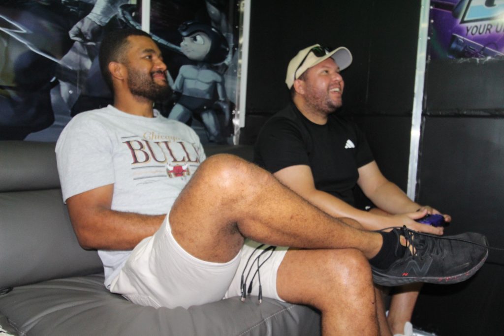 Gamers playing PS5 inside mobile gaming bus in Sydney