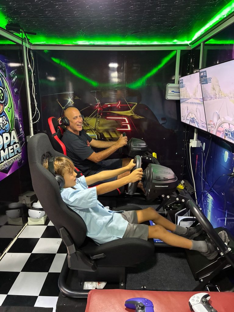 Guest enjoying Party Experience Sydney with PS5 VR2 session with professional Thrustmaster steering wheel and PS5
