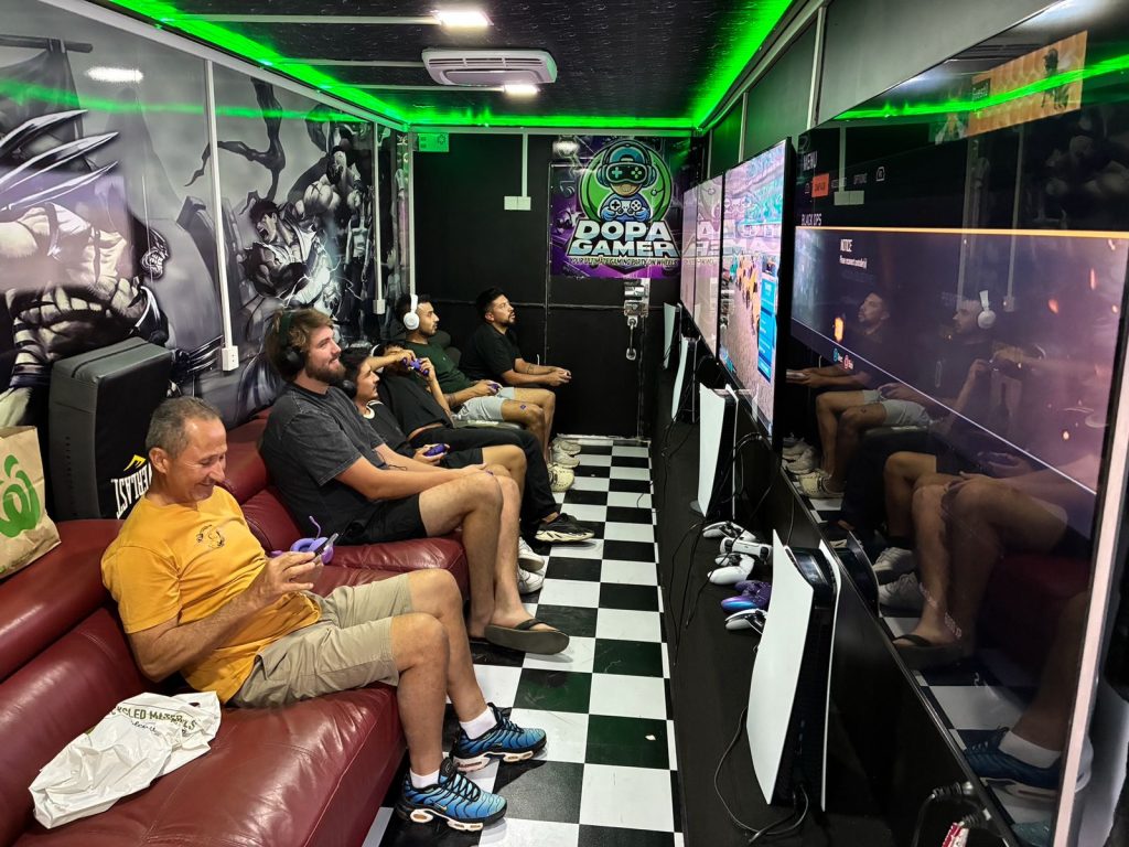 Colleagues competing in video games during a professional team bonding activity in Sydney