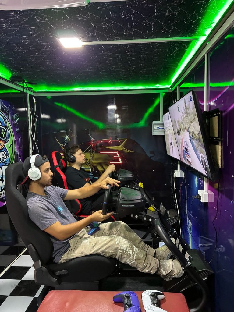 Office staff enjoying a corporate team building session inside Dopa Gamer gaming bus