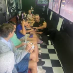 Professional host and expert gaming coaches Sydney managing a multiplayer session inside the gaming bus.