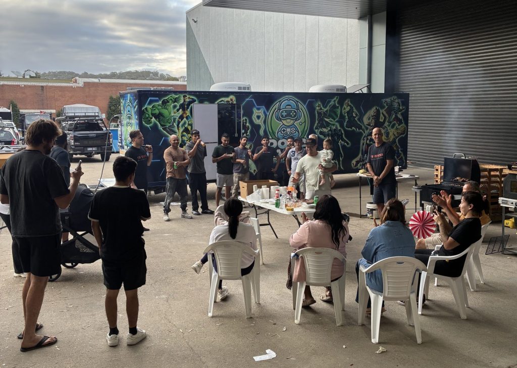 Mobile team building Sydney - Dopa Gamer truck at a corporate outdoor event with staff gathering and BBQ setup.